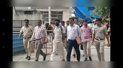 CID officials taking IAS officer Gyanendra Kumar Gangwar to ACMM court on Monday Gyanendra