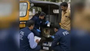 Forensic Science Laboratory (FSL) officers inspect a packet of suspected white powder concealed