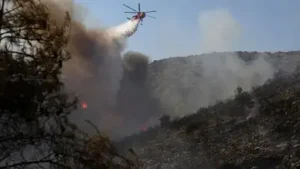 Two wildfires that broke out minutes apart on the Greek island of Salamina on Sunday killed two
