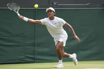 returns to Ivan Ivanov of Bulgaria in the boys' singles final at the Wimbledon Tennis