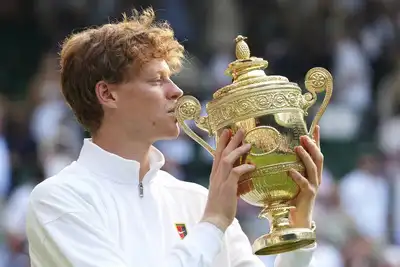 Jannik Sinner of Italy holds the trophy after winning the men's singles final match