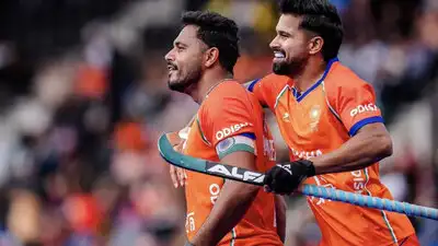 Harmanpreet Singh celebrates with teammate after scoring a goal against Pakistan