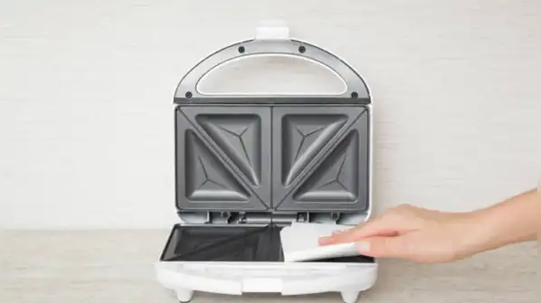 But what exactly happens when you do this, and is it a safe way to clean your sandwich maker?