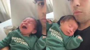 27 In the clip, a father uses a long, low-pitched “Om” sound while holding his crying baby — 28