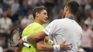 Novak Djokovic, right, embraces Mariano Navone after Navone won their match