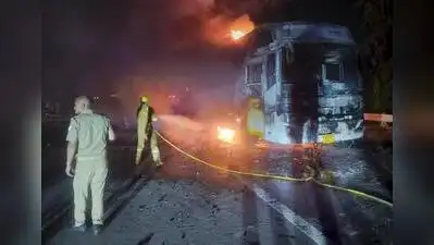 Firefighters at the site after a sleeper bus caught fire on the Yamuna Expressway