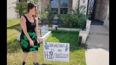 Sara Gonzales puts a 'Nagarjuna is an H-1B trafficker' poster in the lawn of the owner of an IT