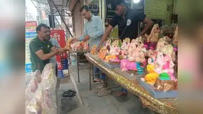 A devotee selecting Ganesh idol from a shop in Raja Bazar area of Chhatrapati Sambhajinagar