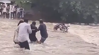 Mahoba police said on X that local people rescued both riders after their motorcycle was swept