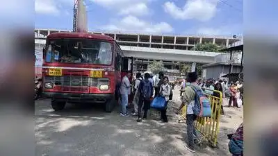 Passengers line up to board a bus at Pune’s Swargate depot