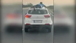 Cop foils smugglers' attempt to escape by clinging on to their SUV for nearly 40km