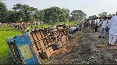 The bus lies overturned near Shivni village after the incident on Friday