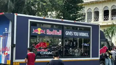 Students gather around an F1 car during Lucknow University’s: The wider industry impact