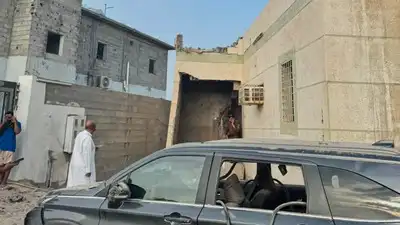 Damaged building and vehicle after Houthi attack in Jazan, Saudi Arabia, on the southern border