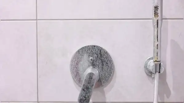 If your water's particularly hard, a light vinegar mist sprayed on after each shower helps keep