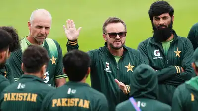 Pakistan's head coach Mike Hesson, center, raises a hand while speaking to the team