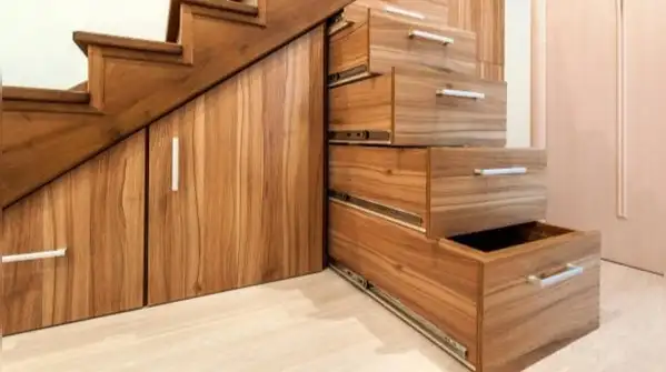 Here's how to turn the space under your stairs into a reading nook, a pantry, or even a small