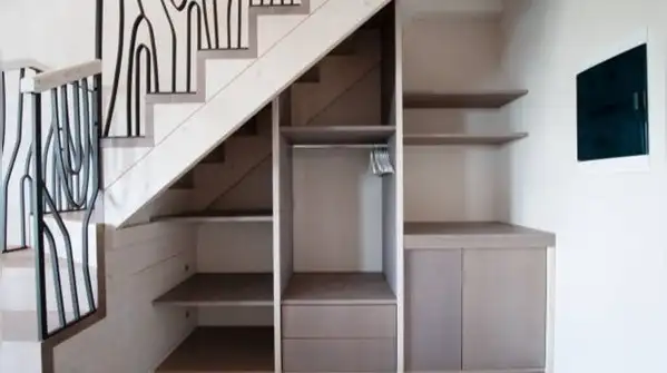 Here's how to turn the space under your stairs into a reading nook, a pantry, or even a small
