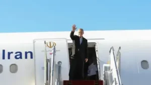 Pezeshkian waves to media and officials as he boards his plane while leaving Mehrabad airport