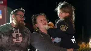 When rescuers reached Payton, they found her sitting in the woods beside one of the family dogs