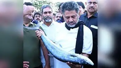 CM DK Shivakumar holds a fish at the fishing port, Bunder (Old Port) in Mangaluru on Saturday