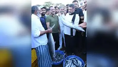 CM DK Shivakumar holds a fish at the fishing port, Bunder (Old Port) in Mangaluru on Saturday