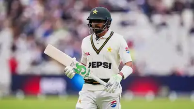 Pakistan's Babar Azam, leaves the pitch, after a wicket taken by England's Josh Tongue Mike