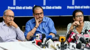 AISA president Neha Bora (L), advocate Prashant Bhushan (R) and RJD MP Manoj Jha (M) announced