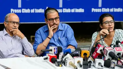 AISA president Neha Bora (L), advocate Prashant Bhushan (R) and RJD MP Manoj Jha (M) announced