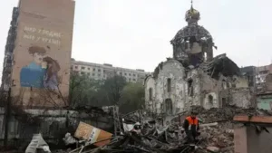 A rescuer walks past a church destroyed by a Russian air strike, (Photo: Reuters)
