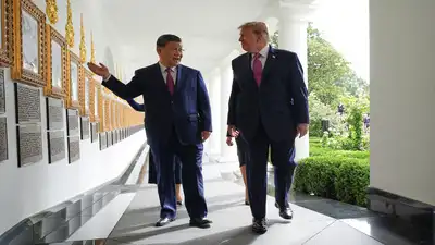 (AP Photo/Jacquelyn Martin) President Donald Trump and China's President Xi Jinping walk along