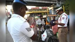 Traffic cops clicking pictures of traffic violators using their mobile phones and checking