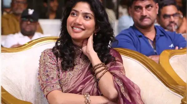 She walked in wearing a rich purple tissue silk saree at the 'Ramayana' Telugu pre-release