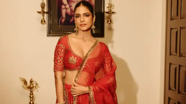Crimson and gold cannot exactly be classified as shrinking violets, and Malavika Mohanan knows