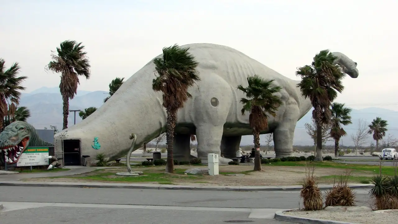 In 1964, a California sculptor began a 150-foot steel-and-concrete dinosaur to lure drivers