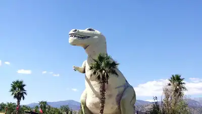 In 1964, a California sculptor began a 150-foot steel-and-concrete dinosaur to lure drivers