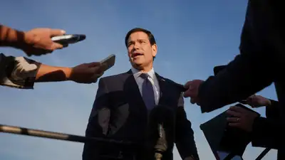 Secretary of State Marco Rubio speaks to the press before boarding a plane at Eleftherios