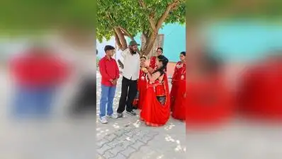 A group of traditionally dressed tharu women welcoming tourists at a home stay