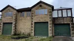 The couple have transformed this disused Land Rover dealership into a family home