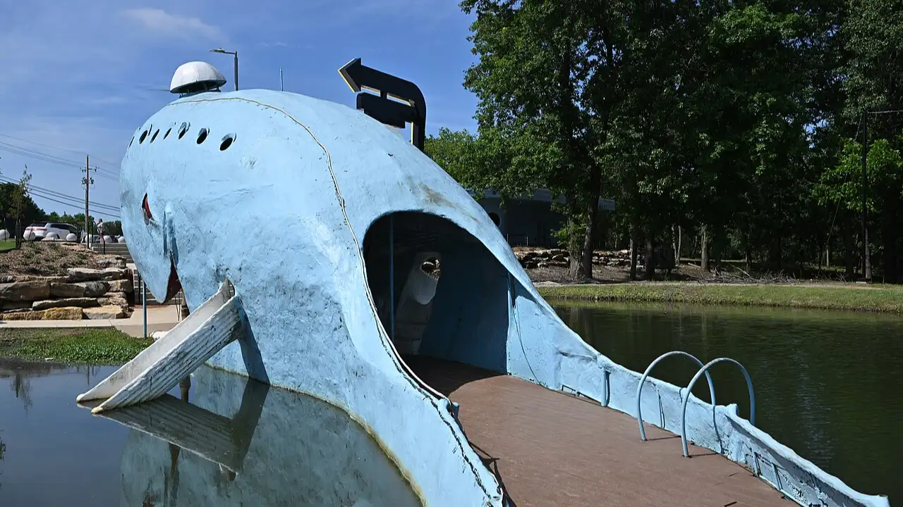 Beside a quiet pond in Oklahoma, an enormous blue whale rises from the grass, and travellers