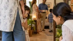 When a toddler hides behind your legs but continues peeking at guests, the behaviour may