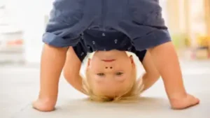 You may have seen your child bend forward, tuck their head between their legs and look