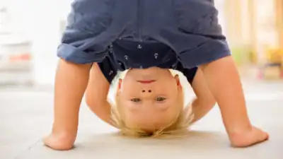 You may have seen your child bend forward, tuck their head between their legs and look