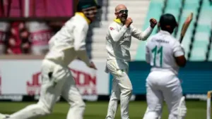 Australia's Nathan Lyon, center, celebrates with his teammates after dismissing South Africa's