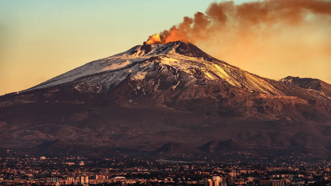 Rising above the Sicilian city of Catania, Mount Etna holds two formidable titles: it is