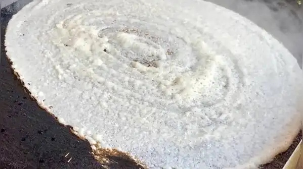 When the surface is too cool, the batter steams instead of crisping, and the dosa turns soft