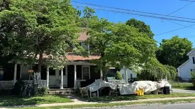 A Connecticut town paid $455,000 for a two-family home to create about 20 library parking spaces
