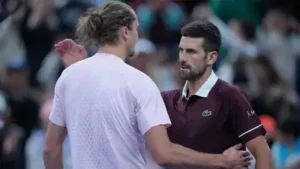 Novak Djokovic is greeted by Alexander Zverev after winning in the men's singles quarterfinals