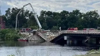 Demolition crews in Maine have started removing damaged parts of a new river bridge that partly